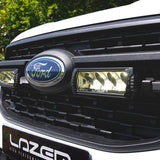 Close-up of a Ford vehicle grille with 'Lazer' branding.
