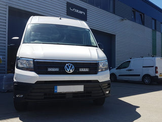 White Volkswagen van in front of a building with 'Lazer' branding.