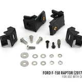 Set of black plastic brackets and metal bolts on a white background with text indicating compatibility for Ford F-150 Raptor.