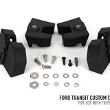 Black automotive suspension lift kit components with screws and washers on a white background, labeled for Ford Transit Custom.