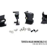 Set of black metal brackets and screws for Toyota Hilux Invincible-X on a white background