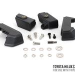 Black mechanical parts and screws on a white background with Toyota Hilux 2021+ text.
