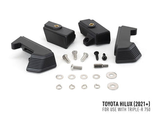 Black mechanical parts and screws on a white background with Toyota Hilux 2021+ text.