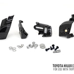 Set of black mechanical parts and screws on a white background with Toyota Hilux 2017+ text.
