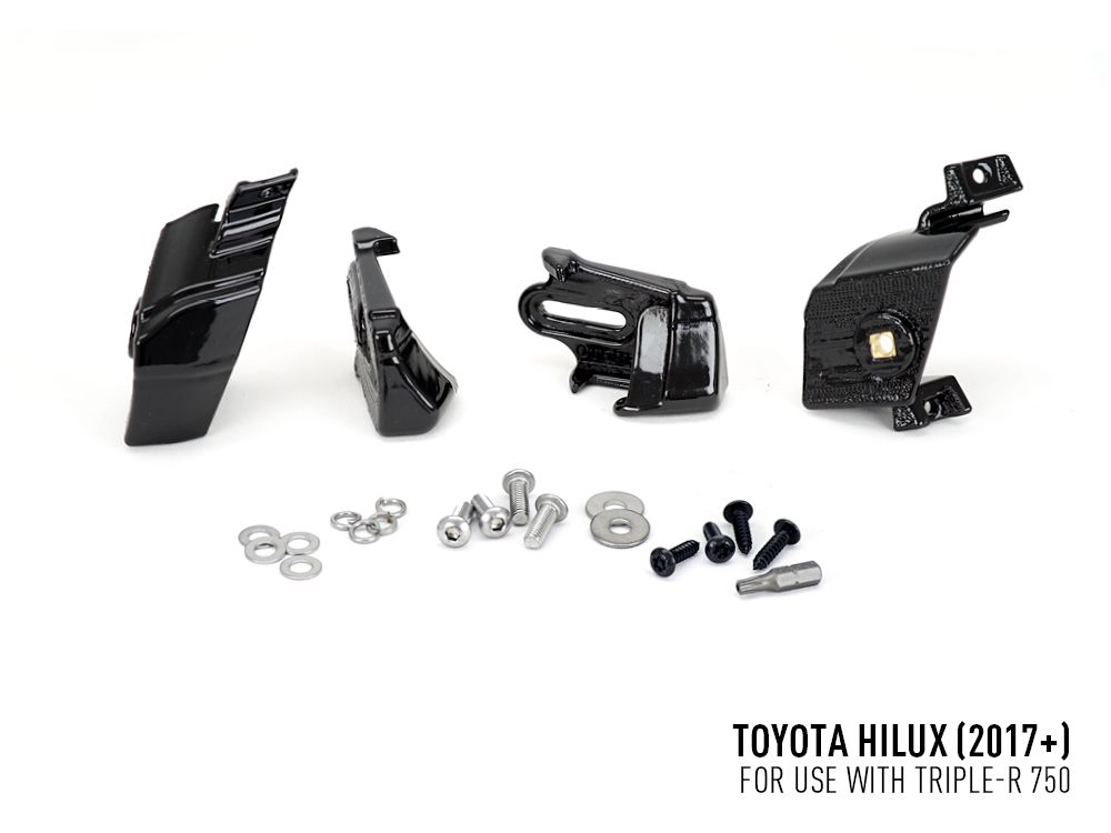 Set of black mechanical parts and screws on a white background with Toyota Hilux 2017+ text.