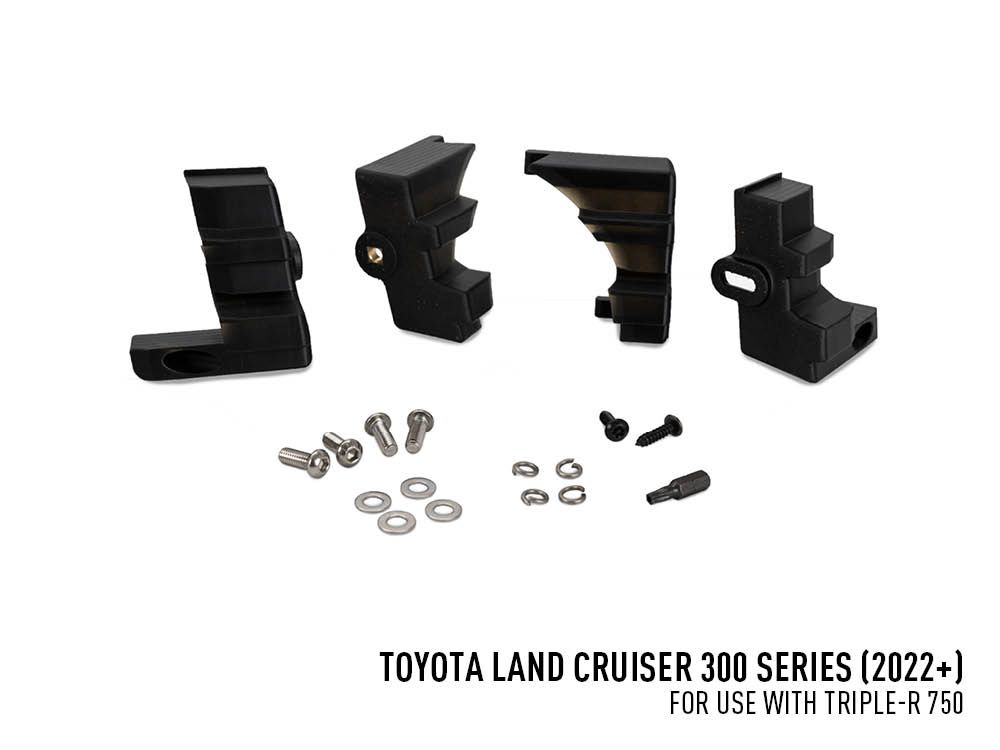 Set of black mechanical components and hardware on a white background with Toyota Land Cruiser 300 Series text.