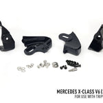 Black mechanical parts and hardware on a white background with Mercedes X-Class V6 text.