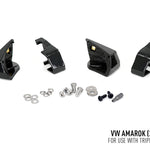 Set of black metal brackets and small metal components on a white background with text indicating compatibility for VW Amarok.