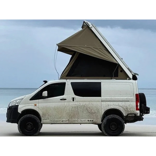 Van with an extended roof tent on a beach