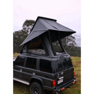 Black SUV with a rooftop tent in a natural setting – Headspace Roof Conversion LC76