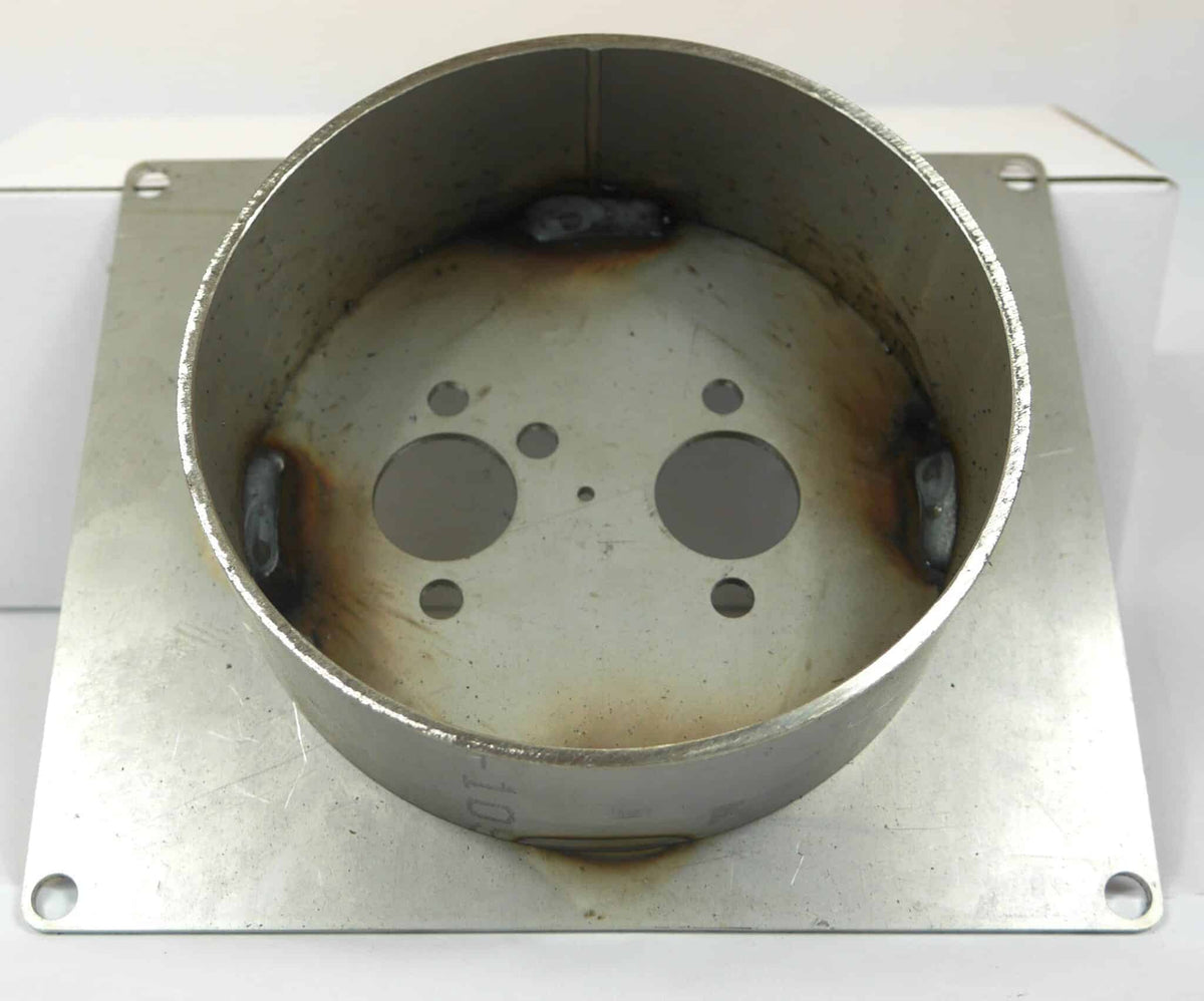 Metal component with circular holes on a white background