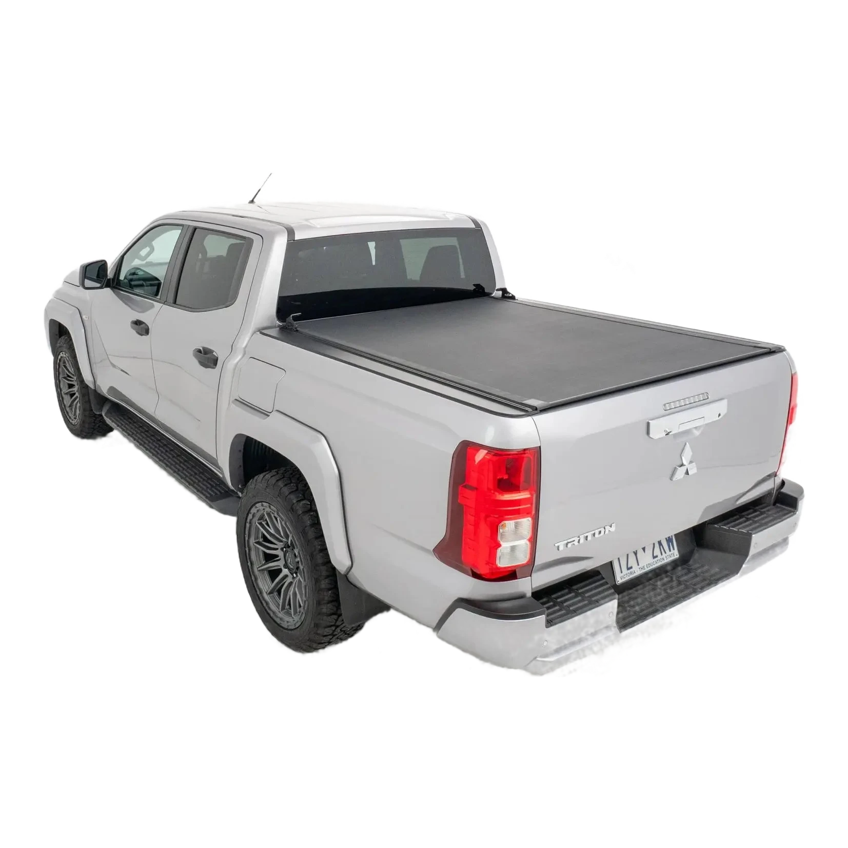 Silver pickup truck with a tonneau cover on a white background – HSP Roll Mate Mitsubishi Triton MV