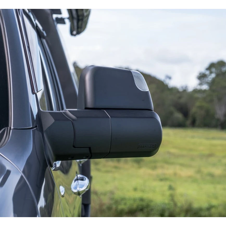Side view of a vehicle's mirror with a blurred natural background – Landcruiser 70-79 Series MSA POWER FOLD Towing Mirrors
