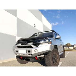 Toyota SUV with off-road modifications parked on a road with a building and blue sky in the background with Lazer Lamps Grille Kit – Toyota Land Cruiser 200 Series (2015–2021)