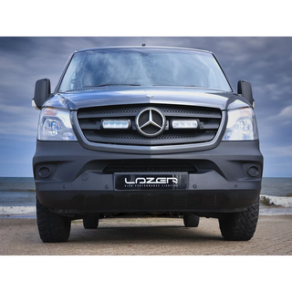 Mercedes-Benz truck with 'Lazer' branding on a beach