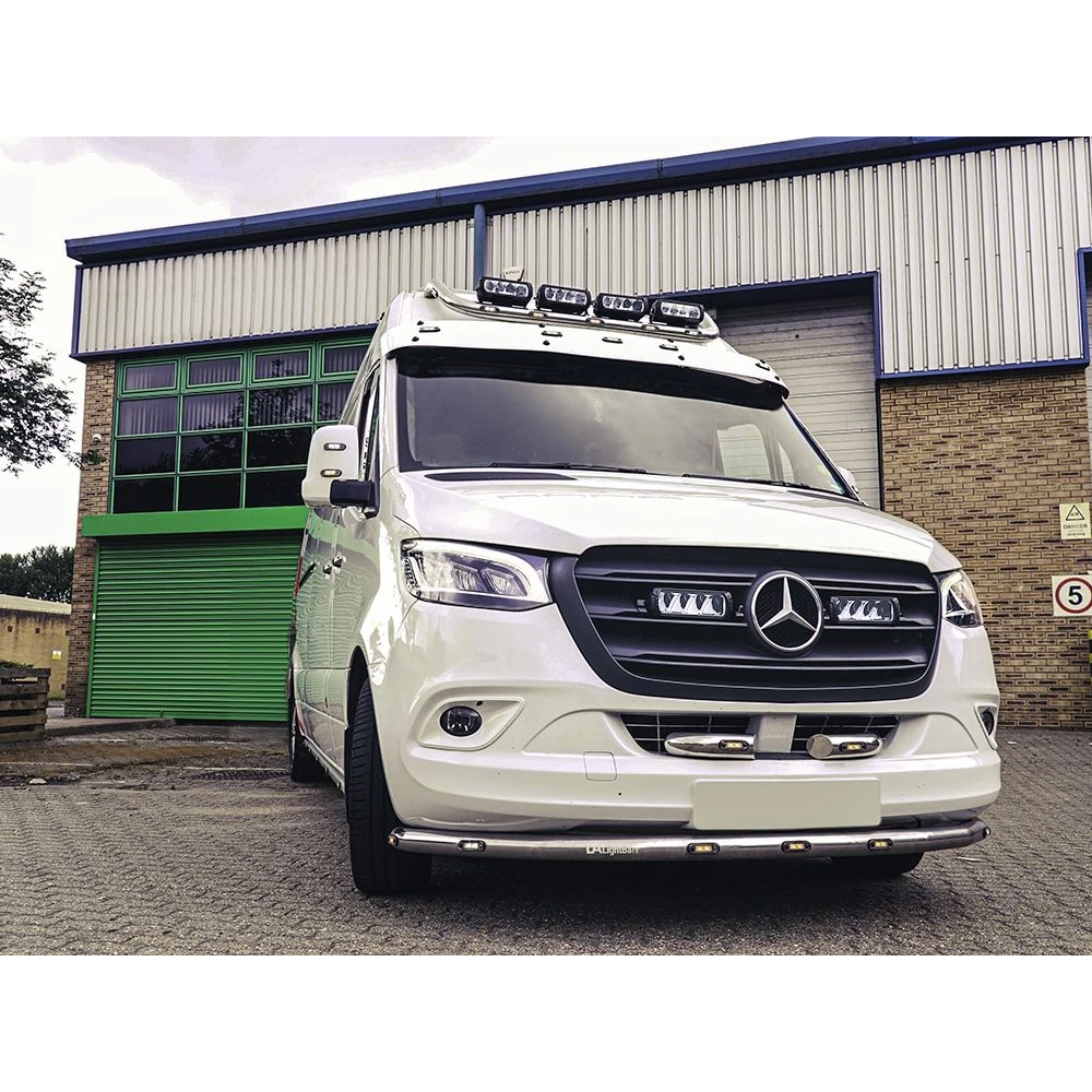 White Mercedes-Benz van in front of a building