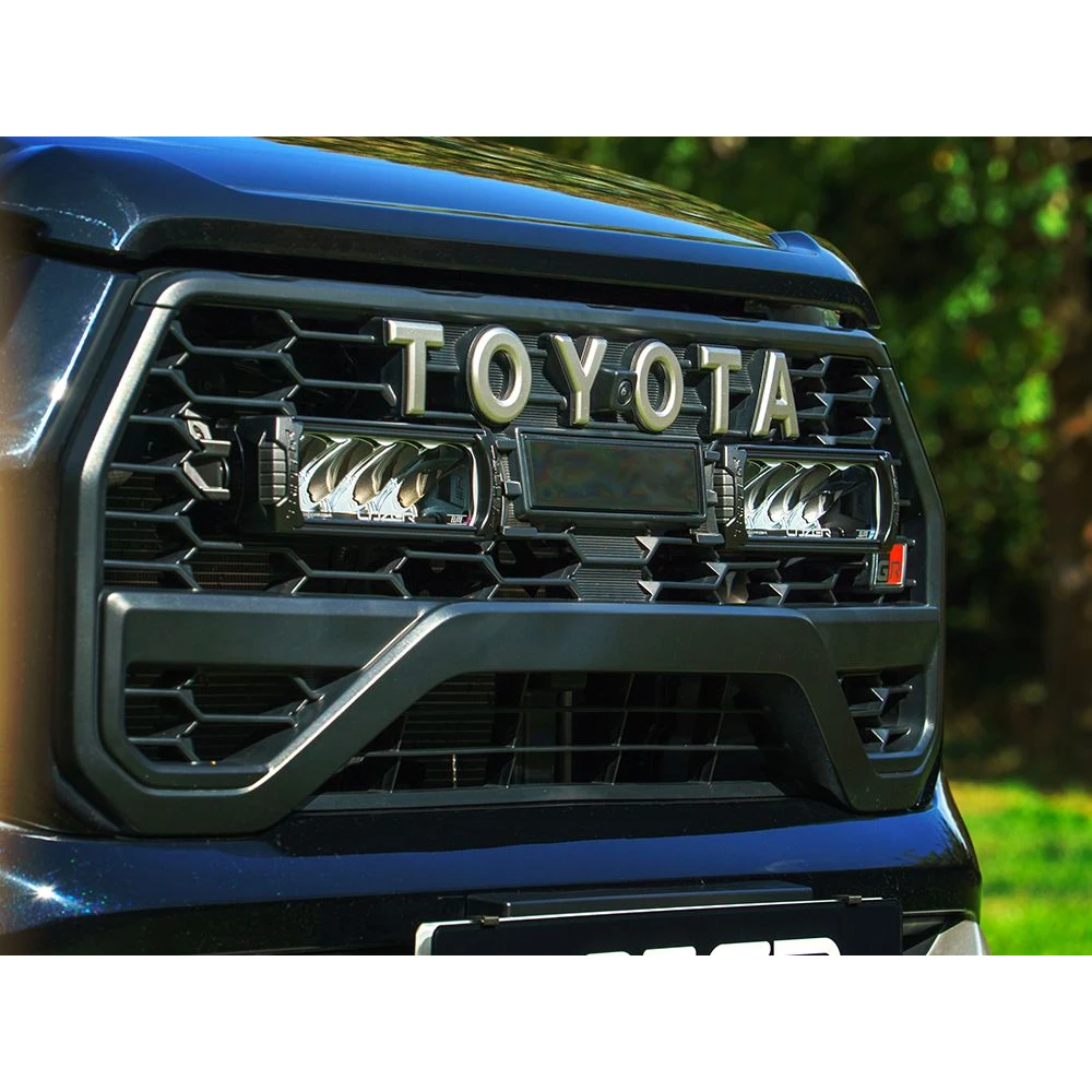 Close-up of a Toyota vehicle grille with Lazer Lamps Toyota Hilux GR Sport (2024+) Grille Kit