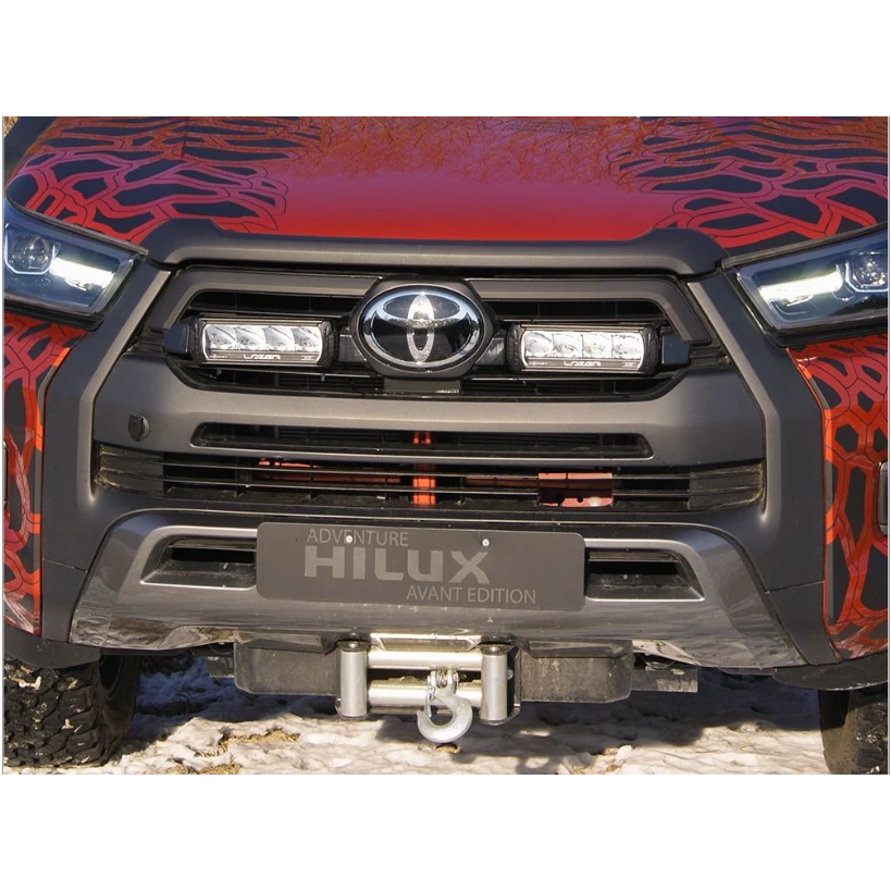 Front view of a Toyota Hilux with a colorful design on the hood.