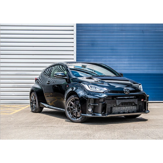 Black Toyota car parked in front of a blue and gray striped wall with Lazer Lamps Bumper Beam Mount Kit for Toyota Yaris GR