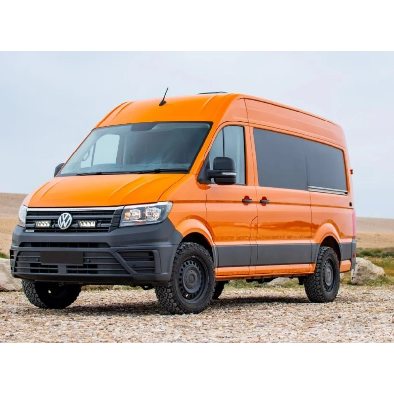 Orange Volkswagen van on a gravel road with a clear sky background with Lazer Lamps Grille Kit for VW Crafter (2017+)