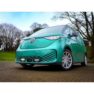 Turquoise Volkswagen car parked on a road with trees in the background with Lazer Lamps Grille Kit for VW ID Buzz (2025+)