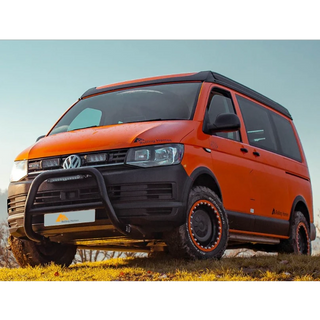 Orange Volkswagen van with off-road modifications on a grassy area with Lazer Lamps Grille Kit for VW Transporter T6 Startline