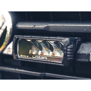 Car fog light with 'Lazer' branding on a vehicle interior.