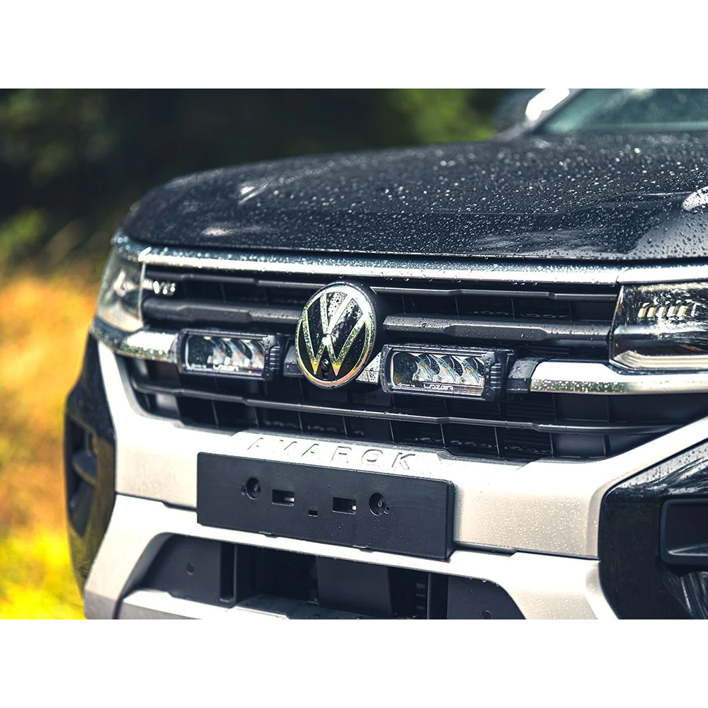 Close-up of a Volkswagen truck's front grille with logo.