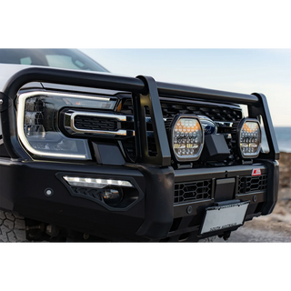 Pair of Lightforce BEAST driving lights fitted to the bullbar of a white Ford Ranger, photographed in daylight