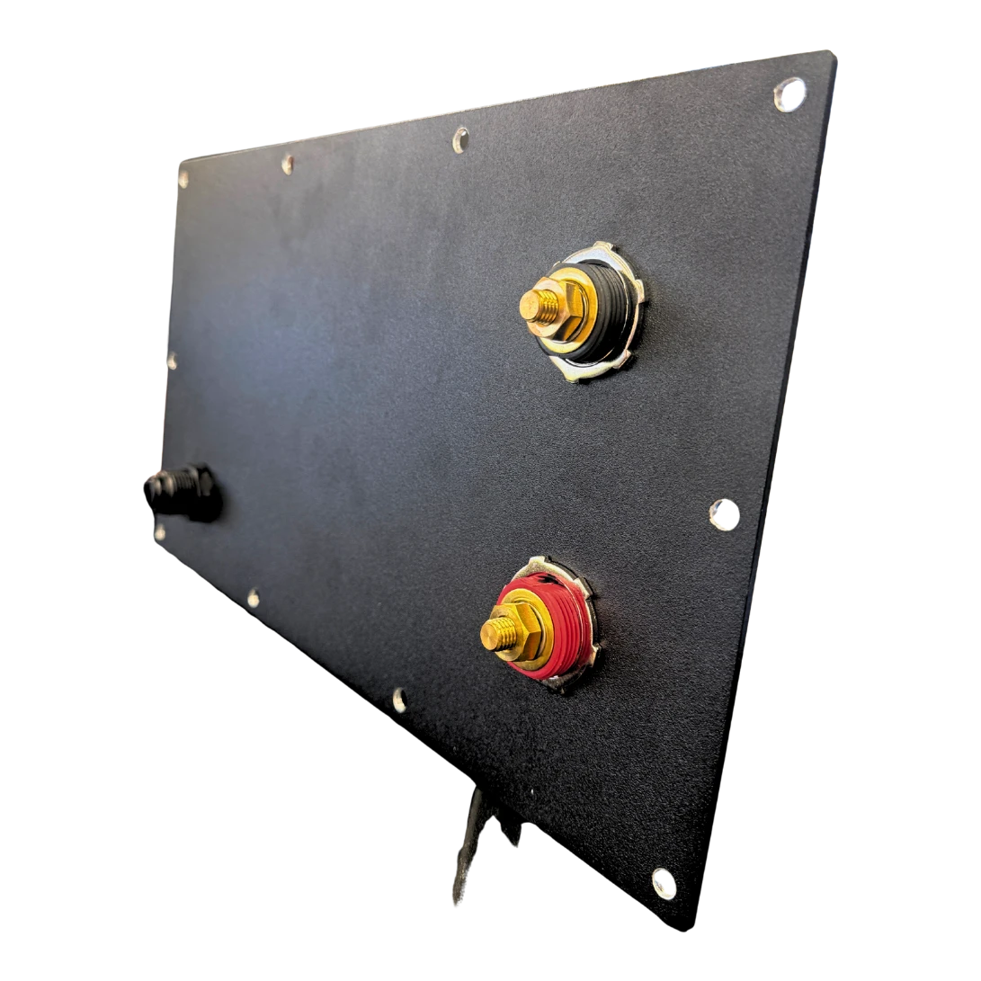 The compartment lid held on edge, showing both insulated terminal studs passing through the plate and the bolt holes spaced around the perimeter – Lithium Battery Compartment