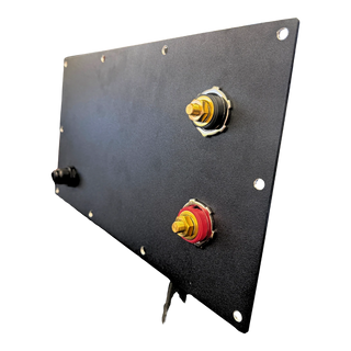 The compartment lid held on edge, showing both insulated terminal studs passing through the plate and the bolt holes spaced around the perimeter – Lithium Battery Compartment