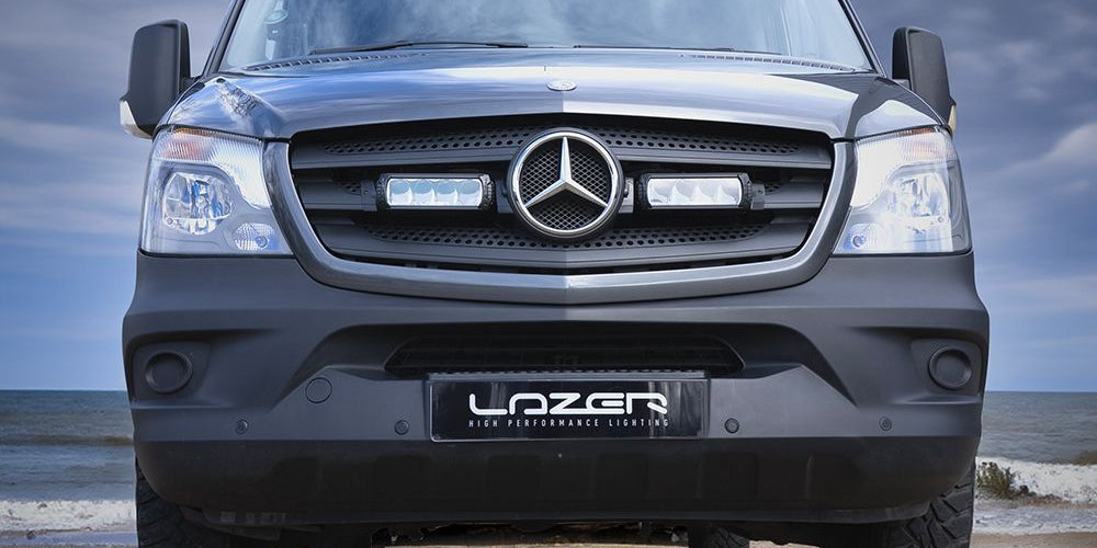 Mercedes-Benz truck with 'Lazer' branding on a beach