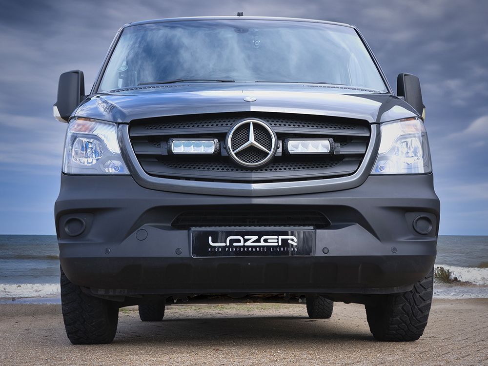 Mercedes-Benz truck with 'Lazer' branding on a beach