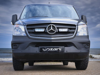 Mercedes-Benz truck with 'Lazer' branding on a beach