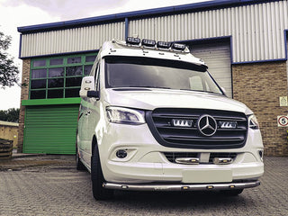 White Mercedes-Benz van in front of a building