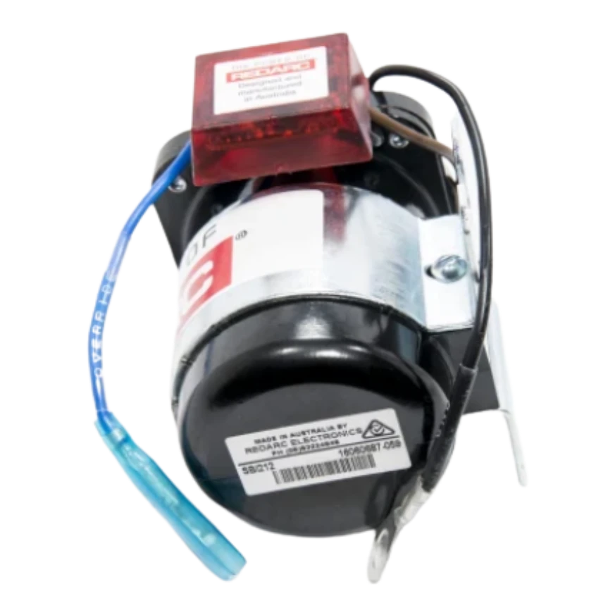 Redarc SBI212 isolator lying on its side, showing the compliance label with the Australian manufacture marking, the SBI212 part number and barcode, and the mounting bracket bolted to the body