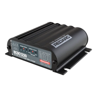 Redarc BCDC1220-IGN 12V 20A under-bonnet DC-DC battery charger — front view of grey potted body with input and output terminals