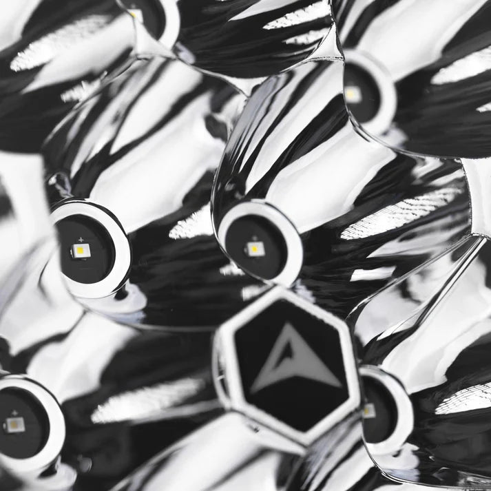 Macro of the Rogue reflector, individual LEDs seated in polished chrome cups around a hexagonal centre badge carrying the ALTIQ arrow
