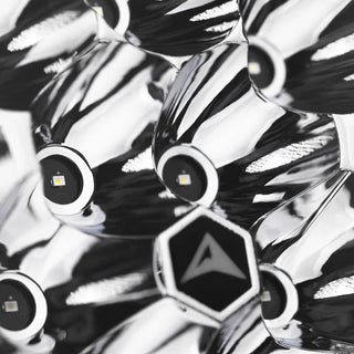 Macro of the Rogue reflector, individual LEDs seated in polished chrome cups around a hexagonal centre badge carrying the ALTIQ arrow