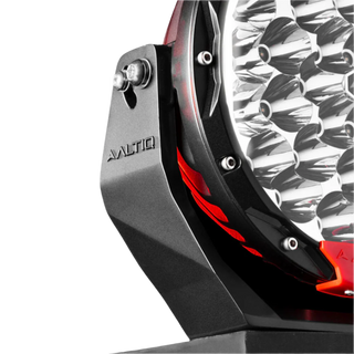 Close-up of the Rogue 8.5 mounting bracket with the ALTIQ name moulded into it, the stainless pivot bolt through the slot, and the chrome reflector cups of the lens visible alongside
