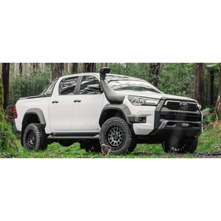 White Toyota truck in a forest setting – SAFARI ARMAX SNORKEL Hilux Wide Body 2015 onwards (Not compatible with Factory flares on 2015-2020 models) (some models require flare kit)