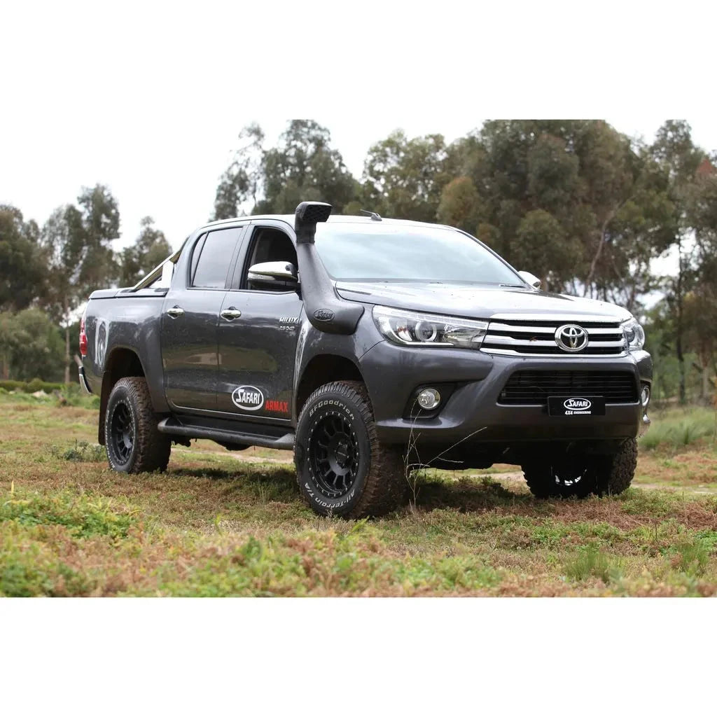 Gray Toyota truck parked in a grassy field with trees in the background – SAFARI ARMAX SNORKEL Hilux Wide Body 2015 onwards (Not compatible with Factory flares on 2015-2020 models) (some models require flare kit)