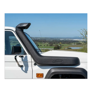 Safari snorkel fitted to a white LandCruiser 70 Series, running up the passenger side of the windscreen to a raised air ram, photographed against farmland and a clear sky
