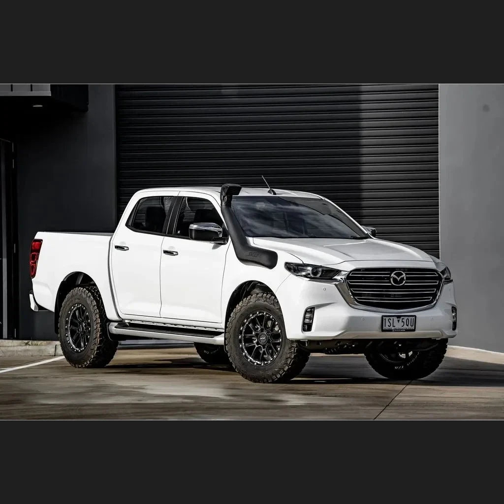 White Mazda BT-50 with Safari V-Spec snorkel parked in front of a grey garage door