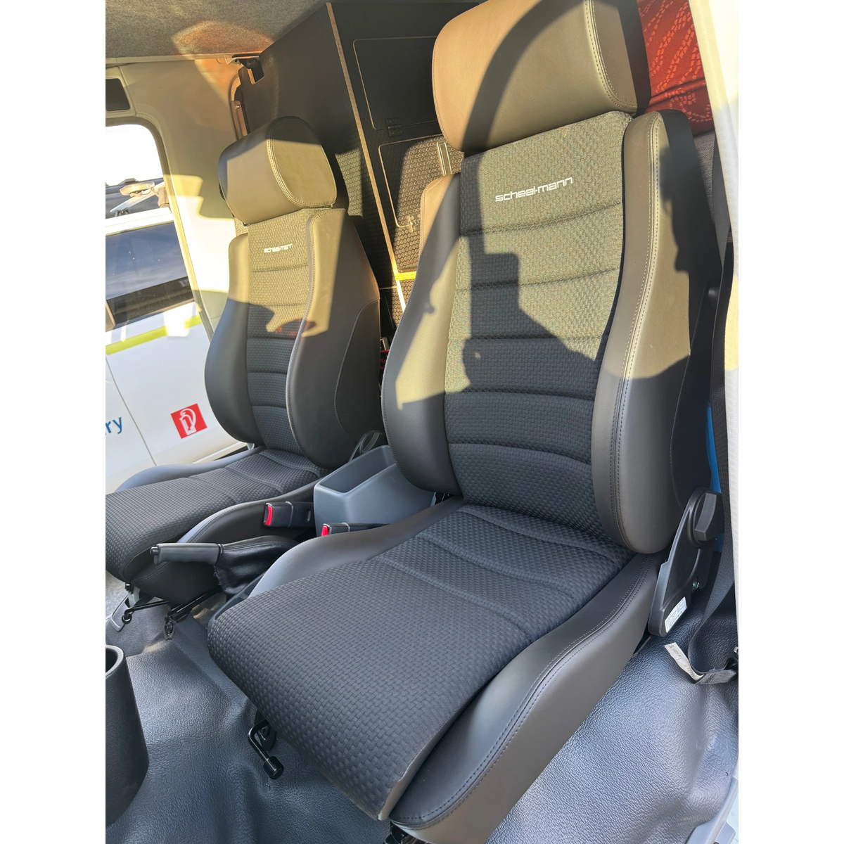 Car interior with folded seat showing brand logo