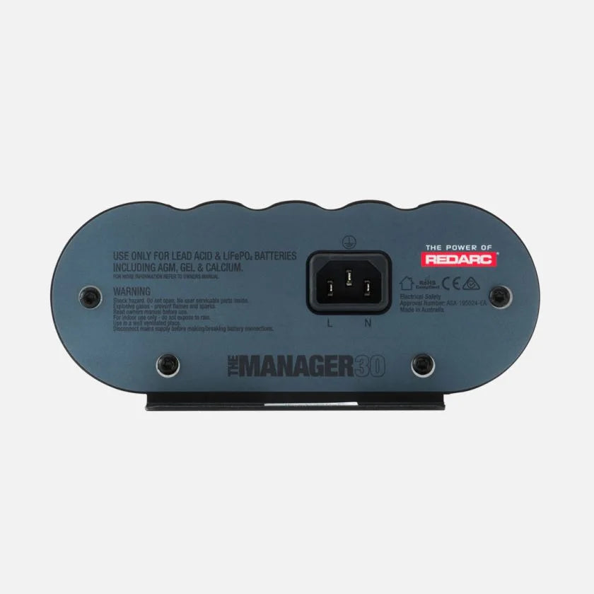 AC input end of the REDARC Manager30 showing the IEC mains socket and the label listing supported battery types