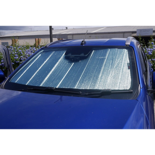 SnapShades Front Windscreen Isuzu MU-X, D-MAX – blue vehicle with the shade covering the windscreen, parked outdoors