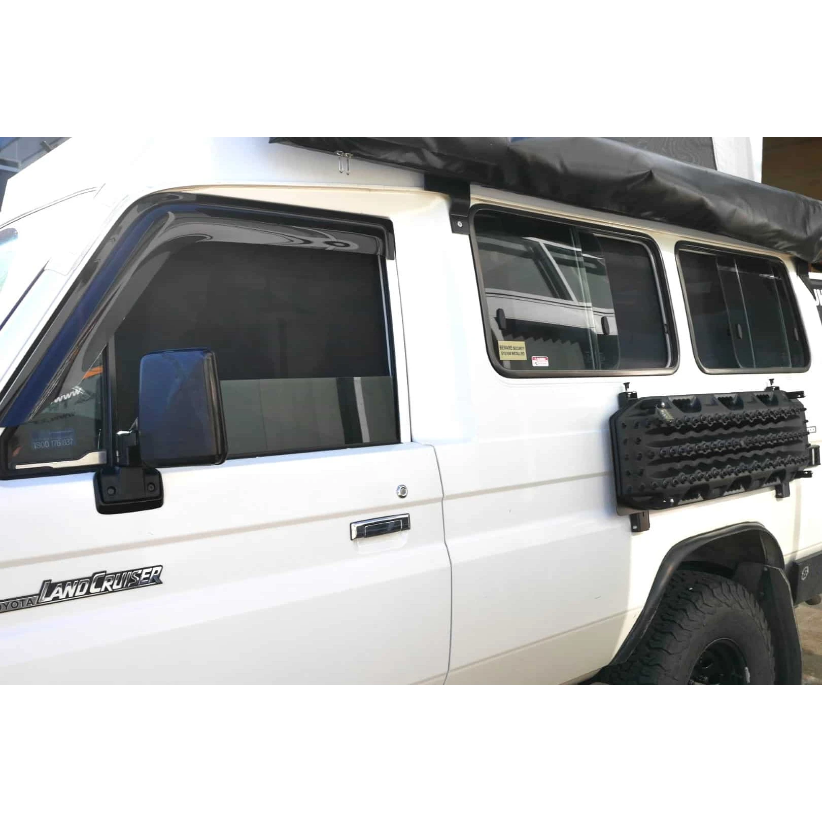 White Landcruiser Troopcarrier with roof rack and SnapShades on the side windows