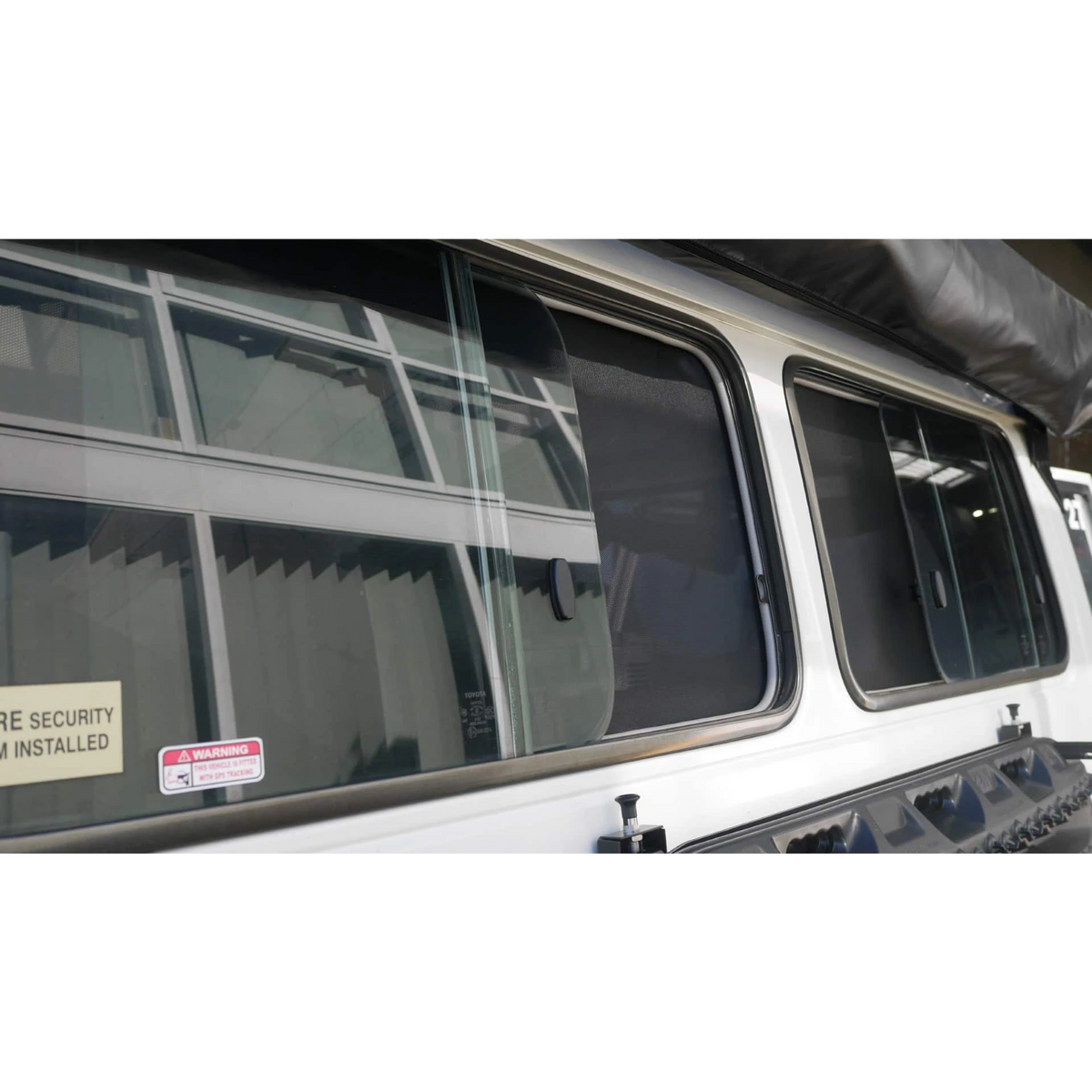Close-up of a Troopcarrier side window with SnapShade fitted – SnapShades Side Port Windows Suit 75/78 Troopcarrier