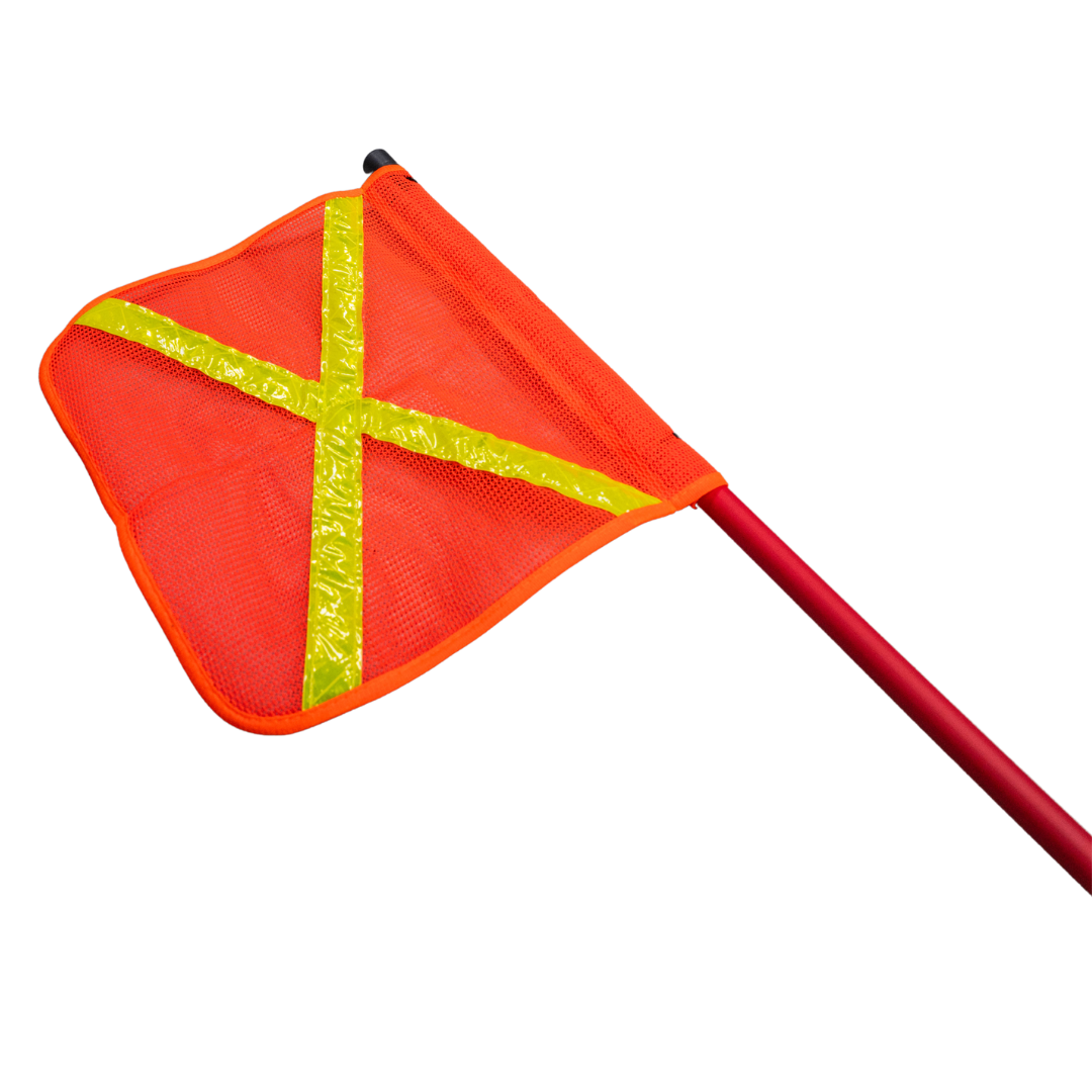 The orange mesh safety flag seen face on with the yellow reflective cross, clipped to the top of the red fibreglass whip
